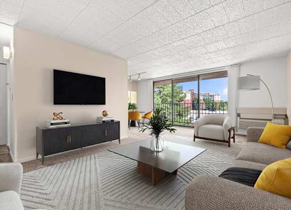 A living room with a flat screen TV mounted on the wall.