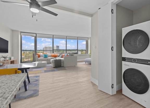 A modern living room with a washing machine built into the wall.