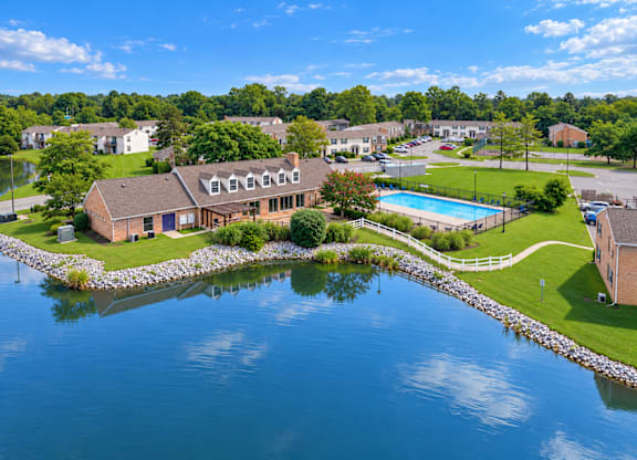 A house is surrounded by water and has a pool.