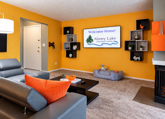A living room with a fireplace and a painting on the wall.