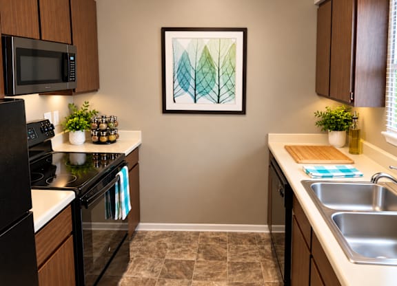 A kitchen with a framed artwork on the wall.
