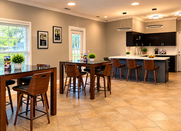 A kitchen with a table and chairs in the middle of the room.
