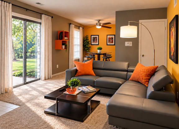 A living room with a grey couch and a coffee table.