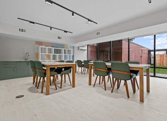 A modern dining room with a wooden table and chairs.