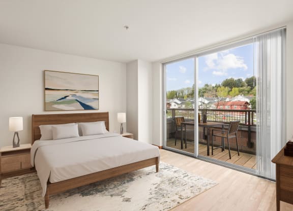 a bedroom with a bed and a large window