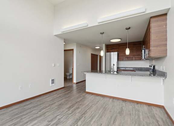 A kitchen area with a countertop and cabinets.