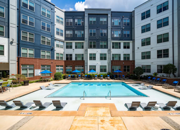 a swimming pool in front of an apartment building