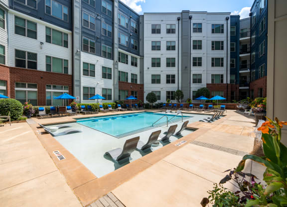 our apartments have a large pool with chairs and umbrellas