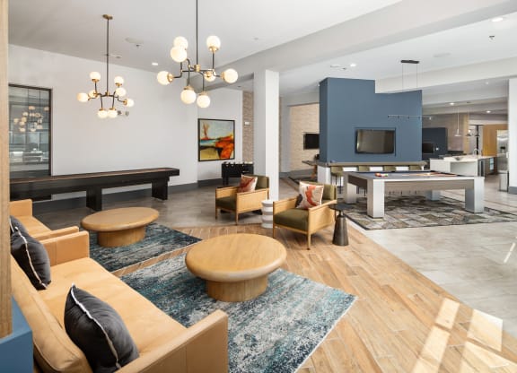 a living room with couches and chairs and a pool table