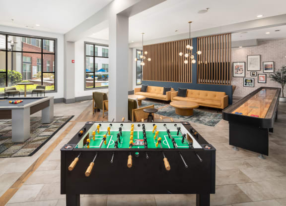 a clubhouse with a pool table and a foosball table