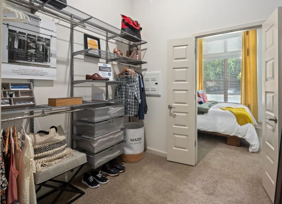 a room with a closet and a bed in the corner