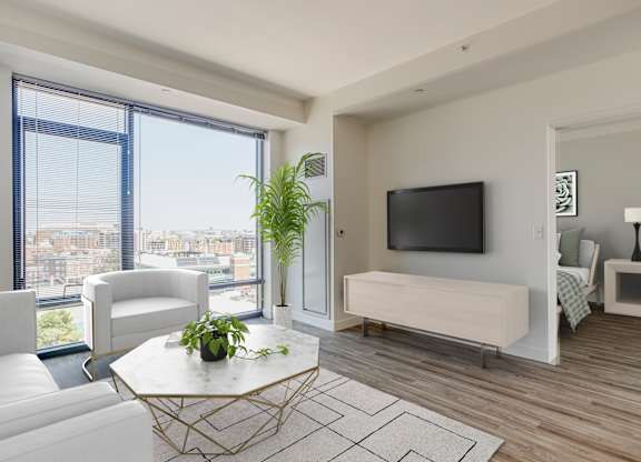 A modern living room with a large window overlooking the city.