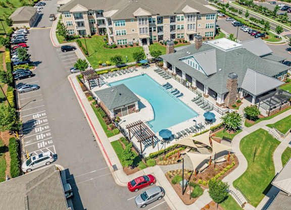 A large building with a pool in front of it.