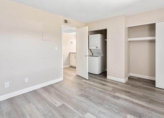 A room with a white fridge and a white door.