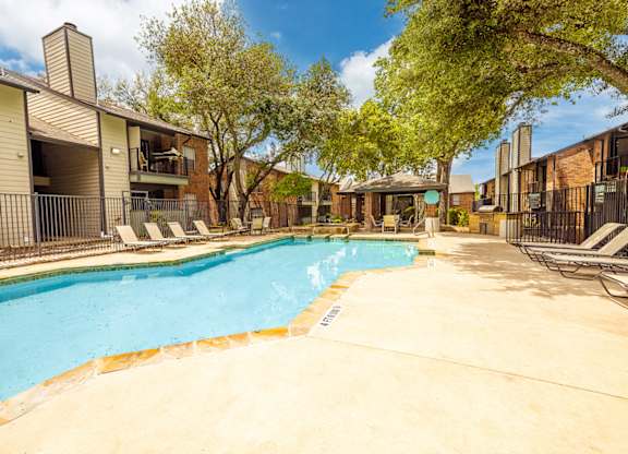 A swimming pool surrounded by apartment buildings.
