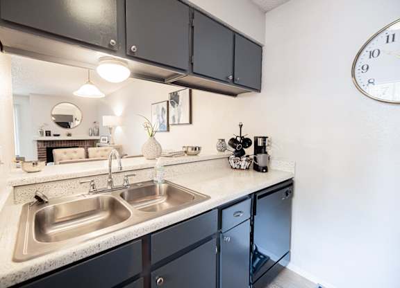 A kitchen with a clock on the wall.