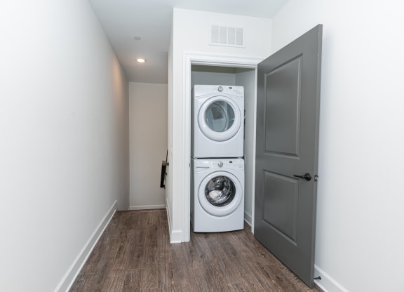 a white washer and dryer in a room with a door