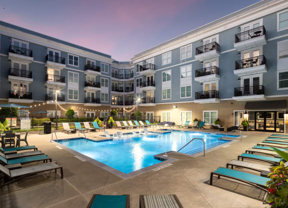 a swimming pool in an apartment building at night