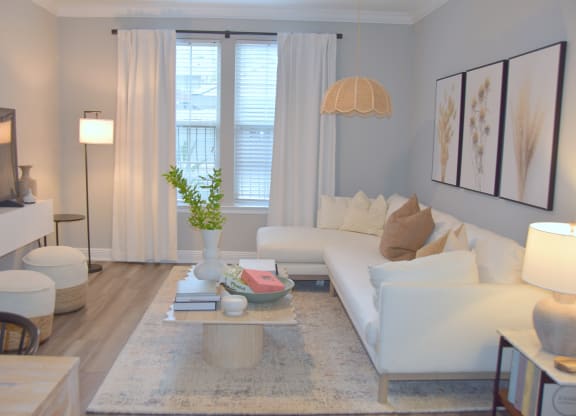 a living room with a white couch and a table