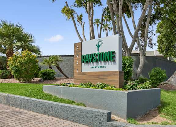 A sign for Day's Stone Spa is displayed in front of a landscaped area.