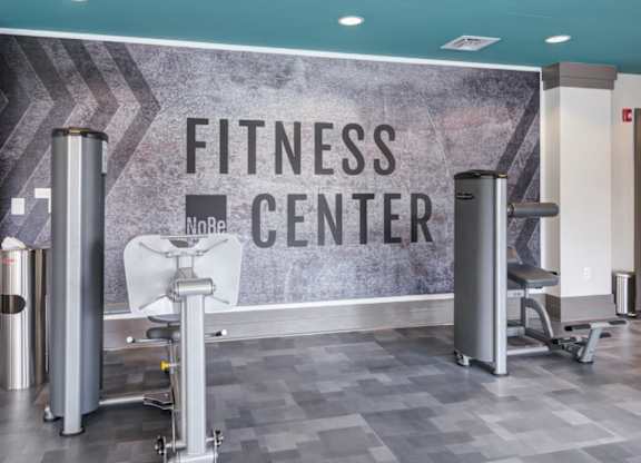 A fitness center with a sign that reads "No Re" and a weight bench.