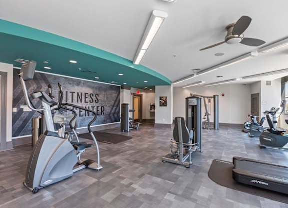 A fitness center with a variety of exercise equipment.