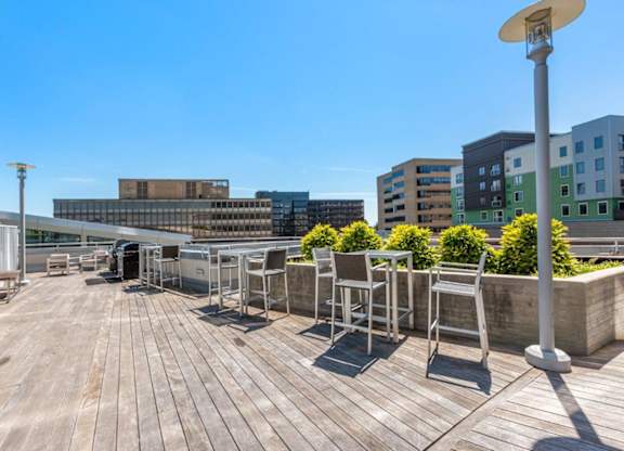 A wooden deck with chairs and a lamp post.