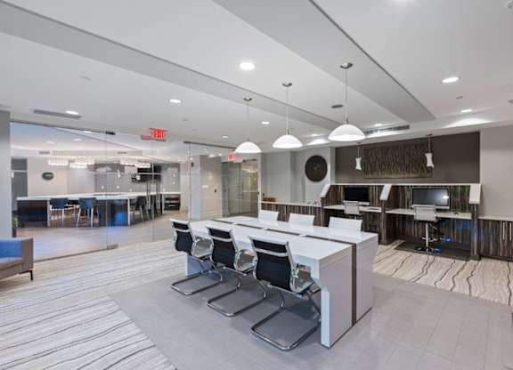 A modern office space with a reception desk and chairs.