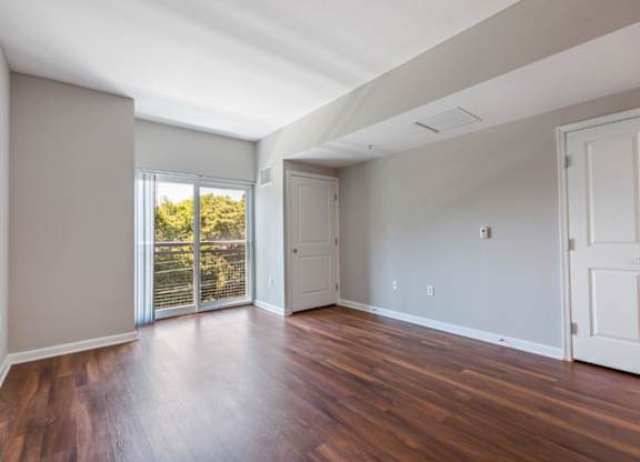 A room with wooden floors and white walls.
