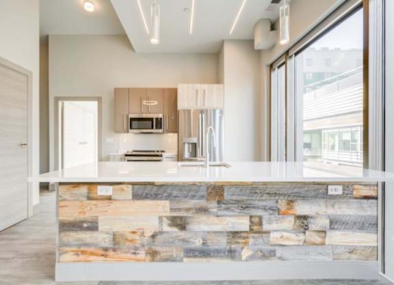 A modern kitchen with a stone counter.