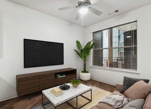 A living room with a flat screen TV mounted on the wall.