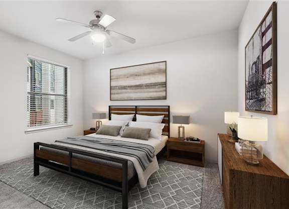 A bedroom with a bed, nightstands, and a ceiling fan.