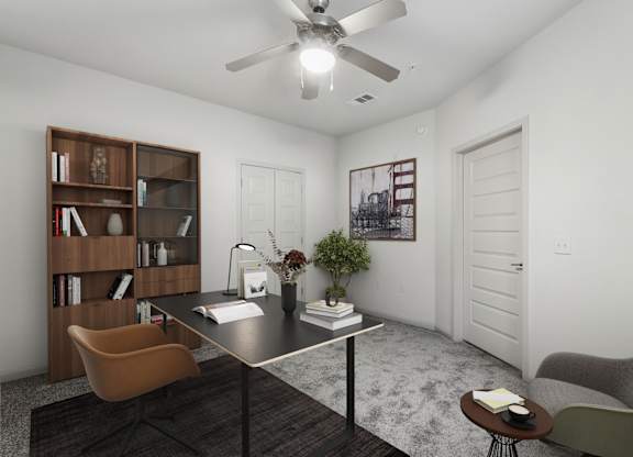 A room with a ceiling fan, a table with a vase of flowers, a bookshelf, and two chairs.