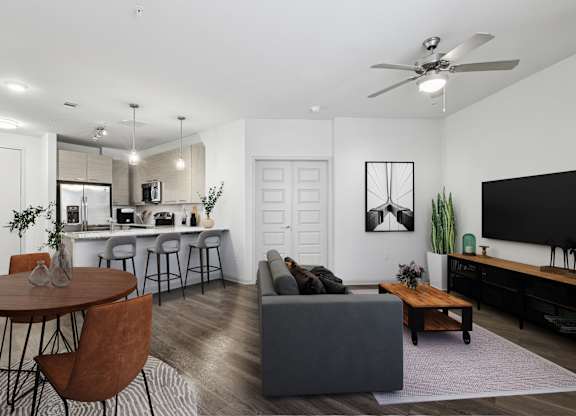 A modern living room with a round table and bar stools.