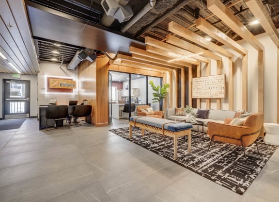 a lobby with couches and chairs and a rug
