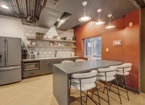 a kitchen with a table and chairs and a refrigerator