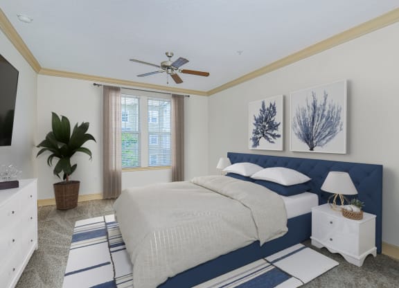 a blue and white bedroom with a bed and a ceiling fan