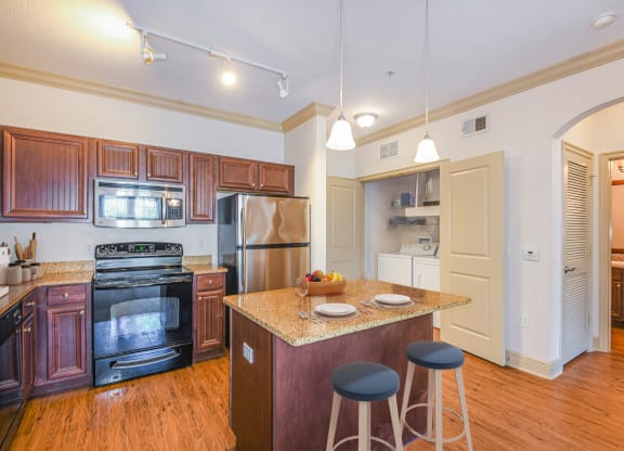 a kitchen with a center island with three stools