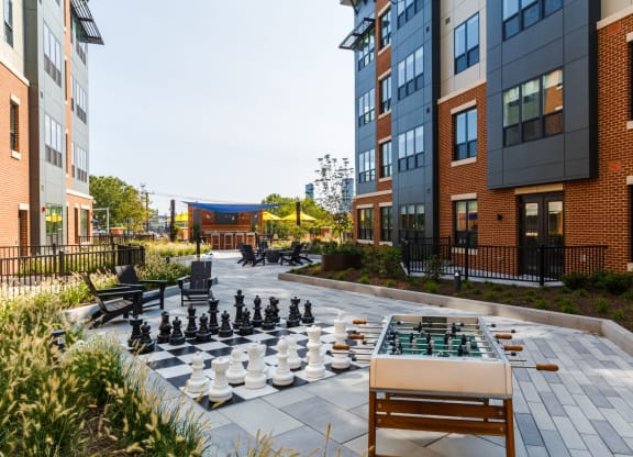 a chess board in the middle of an apartment courtyard at 100 House Apartments, Jersey City , 07310