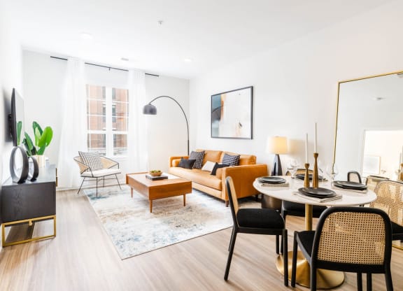 a living room with a round table and a couch at One Ten Apartments, Jersey City , New Jersey