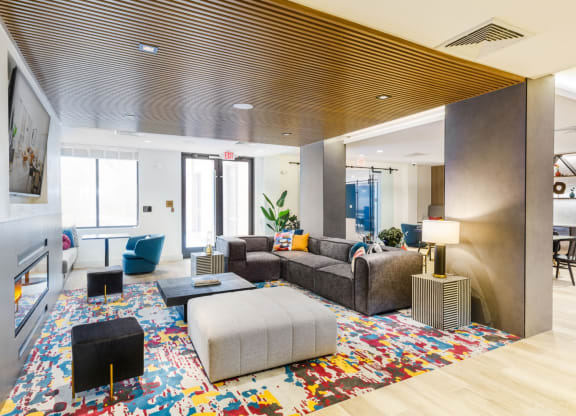a living room with couches and chairs and a rug at One Ten Apartments, New Jersey