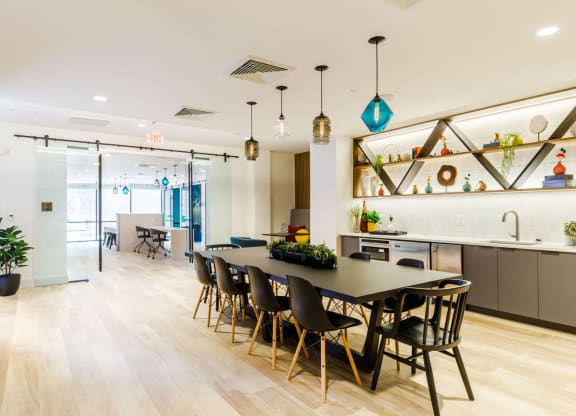 a dining room and kitchen with a table and chairs at One Ten Apartments, New Jersey