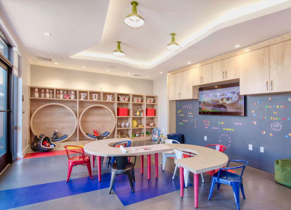 a childs play room with a table and chairs at One Ten Apartments, Jersey City