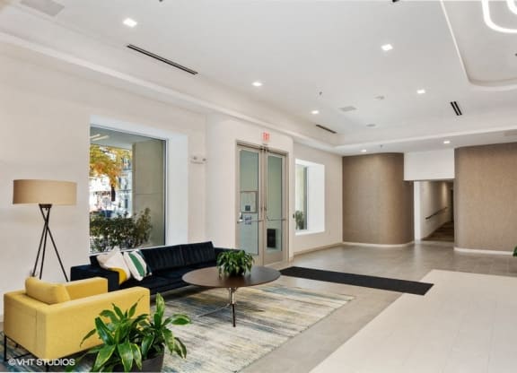 a lobby with a yellow couch and a coffee table at Carver and Slowe Apartments, Washington Washington, DC