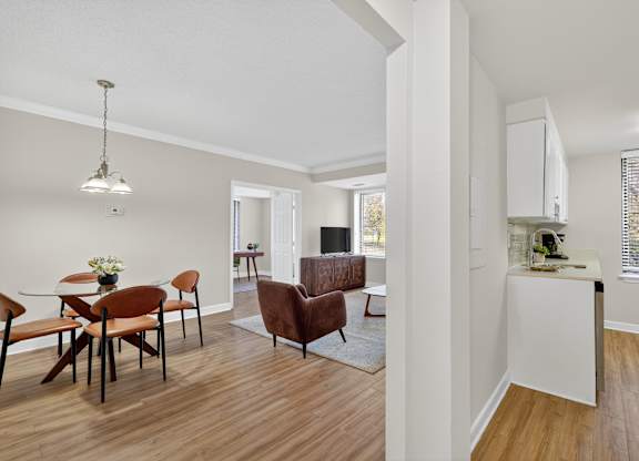 A living room with a dining table and chairs.