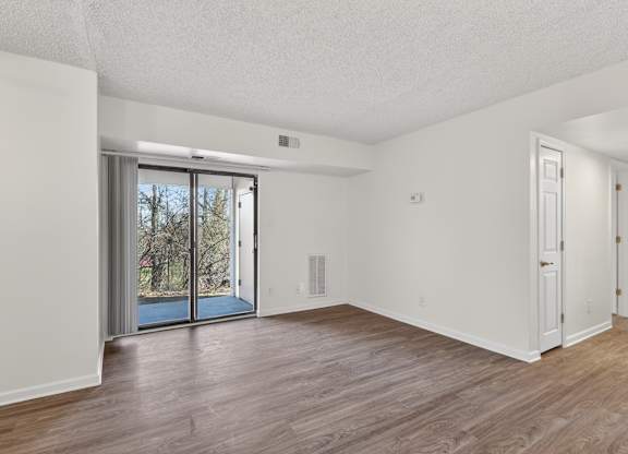 A room with a sliding glass door leading outside.