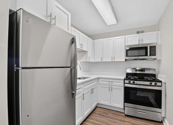 A kitchen with a stainless steel refrigerator and oven.
