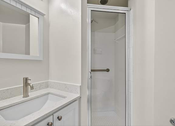 A white sink with a silver faucet in a bathroom.