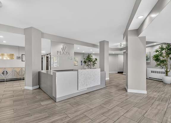 A reception area with a white reception desk and a sign that says
