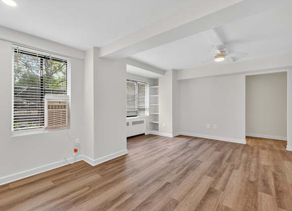A room with wooden flooring and a ceiling fan.